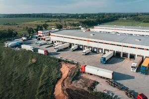 los camiones se cargan y descargan en la terminal de carga - toma aérea de drones. foto