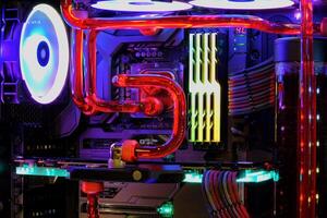 inside desktop pc and water cooling system on cpu socket with led neon light show status photo