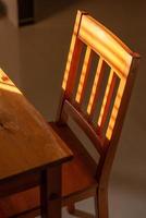 Wooden chair and table in a sunlit house photo