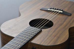 Acoustic guitar close-up on a beautiful colored background, the concept of stringed instruments photo