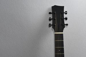 Acoustic guitar close-up on a beautiful colored background, the concept of stringed instruments photo