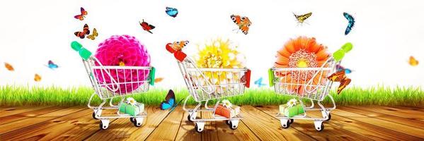 Mini shopping cart with colorful flowers and butterflies. photo