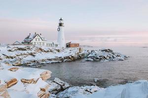 Snowy coastal landscape with lighthouse