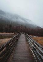 Wooden path to foggy mountains