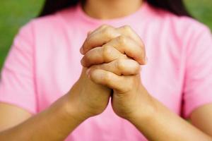 woman uses her hands to make a wish symbol. photo