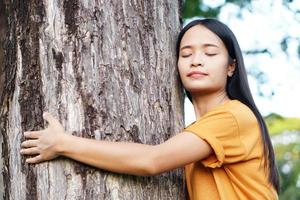 Asian women huging trees , the concept of love for the world photo