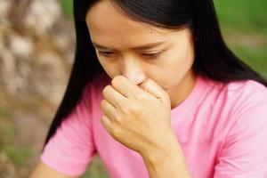 asian women has an itchy nose. photo