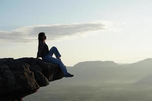 Female tourist on the mountain looking at nature photo