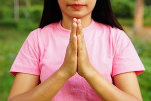 woman uses her hands to make a wish symbol. photo