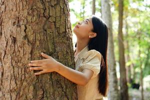 Asian women huging trees , the concept of love for the world photo