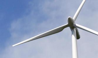 Wind turbine spinning to generate electricity for households. clean and sustainable energy concept. 3D illustration rendering photo