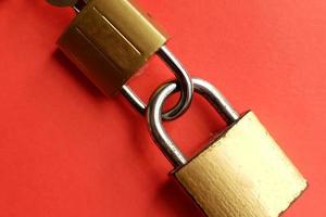 Two padlocks locked with each other photo