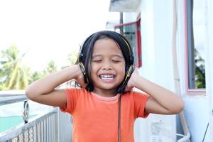 little girl expression wearing a headset on her head photo