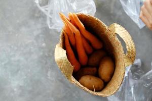 woman holding a basket of vegetables photo