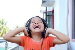 little girl expression wearing a headset on her head photo