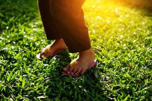 parte del pie de una niña en el parque bajo el cálido sol de la tarde foto