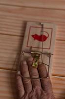man's hand caught in a mouse trap