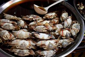 Blue Swimming Crabs preserve by fish sauce are on tray for selling in Thailand .