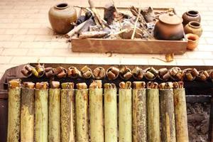 Sticky rice roasted in bamboo join or Khao Lam are roasting on stove. In Thailand Khao Lam is favorite thai dessert and must cracked the bamboo before eat.