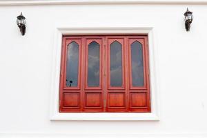 Red brown wood window and white wall, retro style window is closed. photo