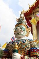 Giant statue in Thai ancient native art is standing in temple, front of church, Thailand.