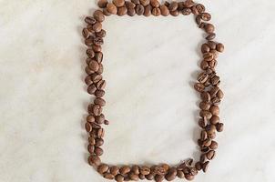 vertical frame of coffee beans on a light background photo