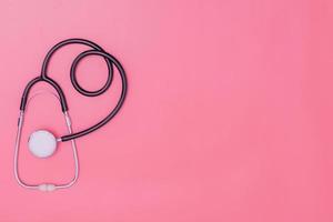stethoscope on pink background and copy space photo