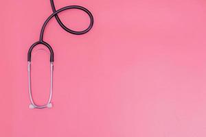 stethoscope on pink background and copy space photo