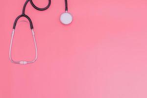 stethoscope on pink background and copy space photo