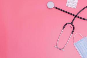 stethoscope on pink background and copy space photo