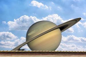 Planet Saturn on the blue sky photo