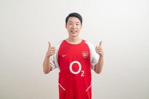 Bangkok, THAILAND - Nov 27, 2021 - Young Asian man wearing Arsenal shirt with white background. photo