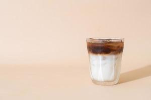 iced coffee with milk layer in glass photo