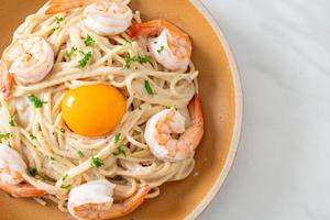 spaghetti white cream sauce with shrimps and egg yolk photo