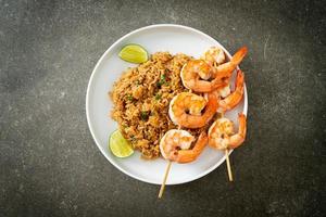 fried rice with shrimps skewers photo