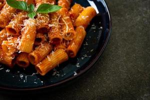Rigatoni pasta with tomato sauce and cheese photo
