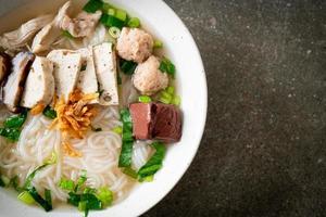 Vietnamese Rice Noodles Soup with Vietnamese Sausage served vegetables and crispy onion photo