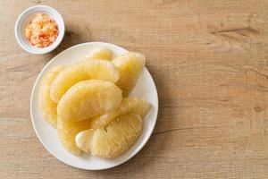 Fresh peeled pomelo, grapefruit or shaddock photo