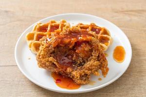 fried chicken with waffle and spicy sauce