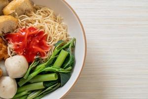 egg noodles with fish balls and shrimp balls in pink sauce, Yen Ta Four or Yen Ta Fo photo