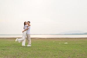 Happy young Asian couple in bride and groom t-shirt photo