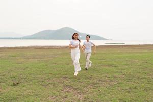 Happy young Asian couple in bride and groom t-shirt photo