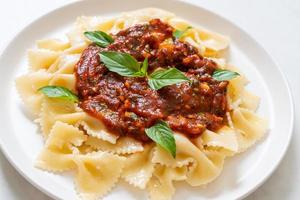 farfalle pasta with basil and garlic in tomato sauce photo