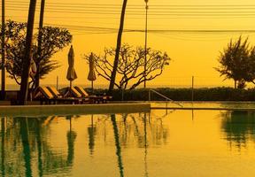 umbrella with bed pool around swimming pool with ocean sea background photo