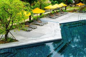 umbrella and pool bed around swimming pool photo