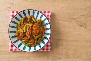 Stir fried pork with red curry paste photo