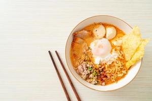 instant noodles with pork and meatballs in spicy soup
