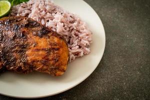 spicy grilled Jamaican jerk chicken with rice photo