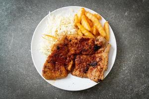 grilled spicy barbecue pork steak with french fries photo