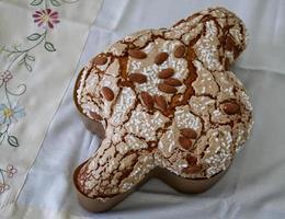 Colomba di Pasqua. Dove Cake topped with icing and almonds. Italian Easter dessert. photo